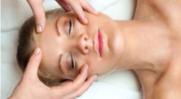 Woman receiving facial massage treatment for skin health and circulation benefits