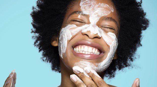 Woman applying sunscreen for summer sun protection and skin care